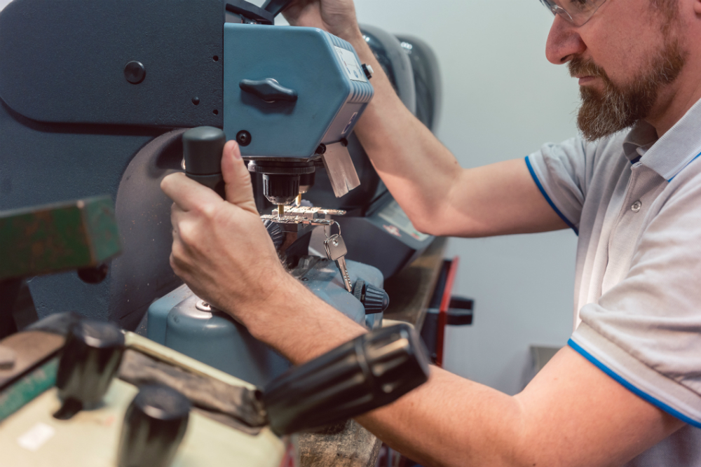 locksmith is operating a key cutting machine